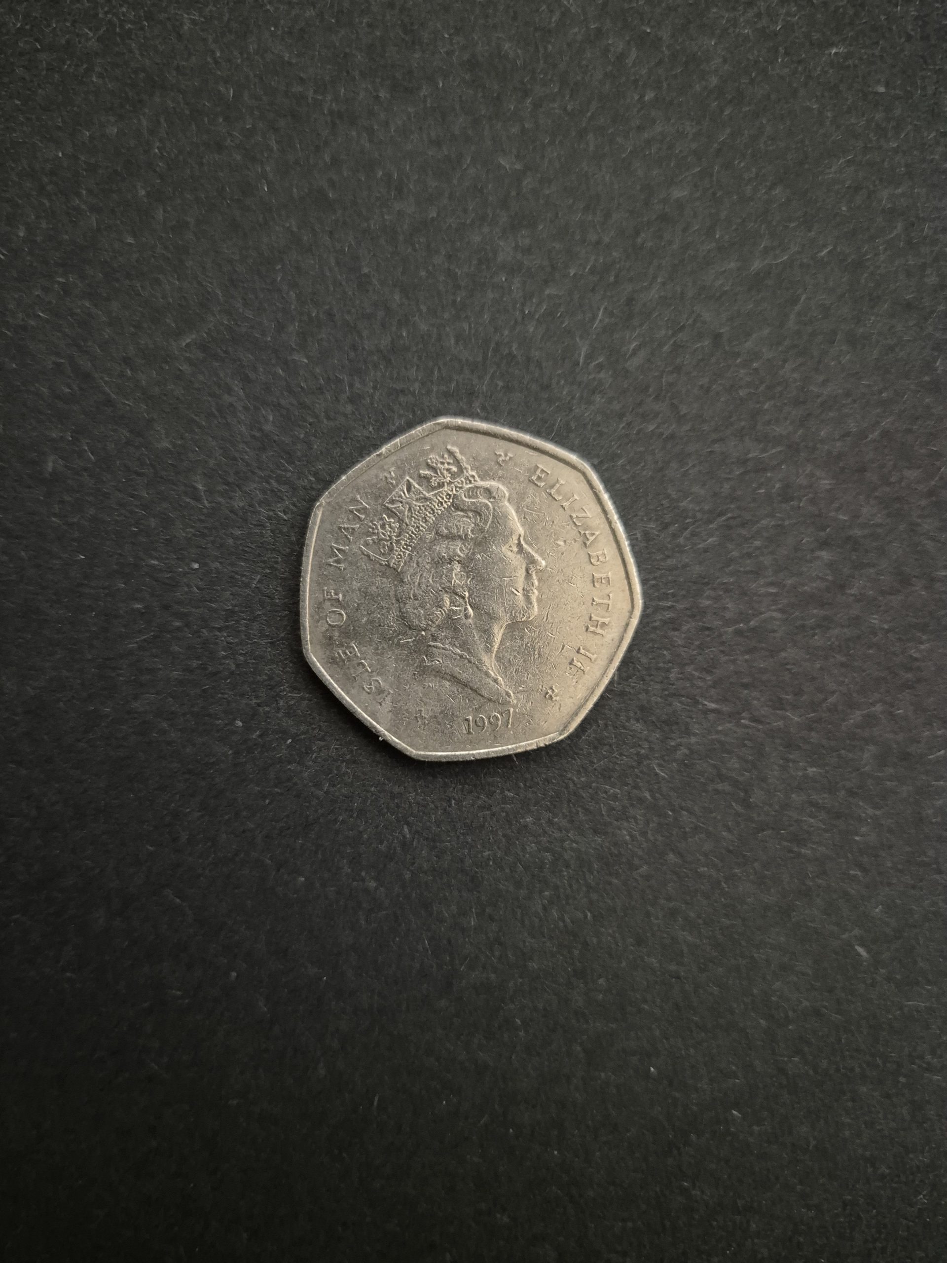 1997 Isle of Man 50p TT Races Coin - Rare Collector's Item Image of a 1997 Isle of Man 50 pence coin featuring a profile of Queen Elizabeth II, commemorating the TT Races.