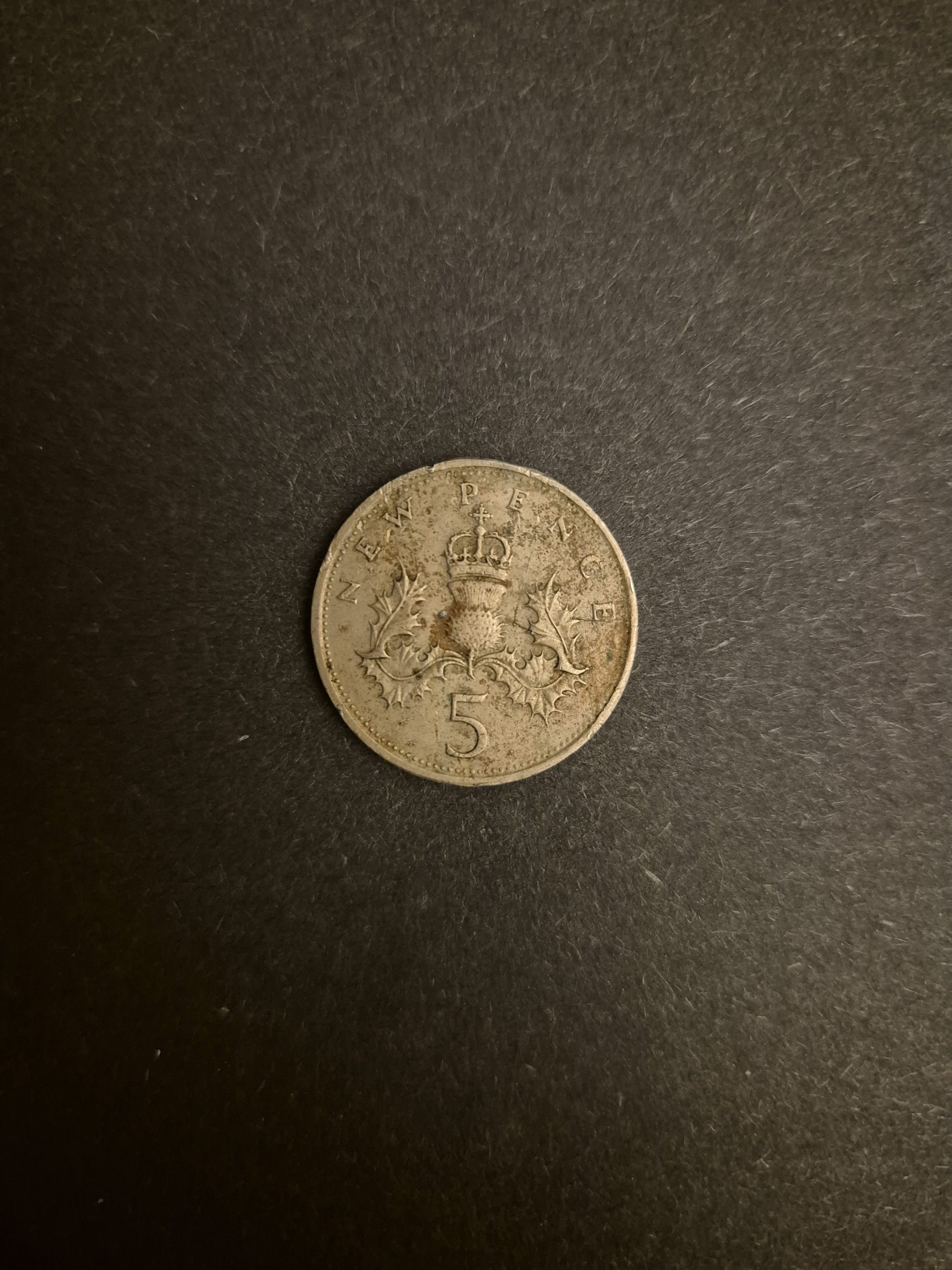1980 5p New Pence Coin - British Currency Collectible Close-up image of a 1980 British 5p New Pence coin, showing the thistle design and details on the reverse side.